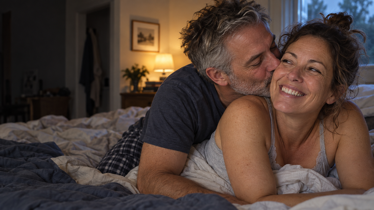 Man kissing his partner on the cheek, both smiling